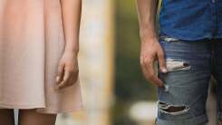 couple standing side by side, not touching