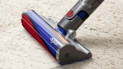 The black, red and blue head of a Dyson vacuum