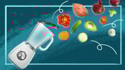 illustration of a food processor with an open lid and vegetables flying out of it