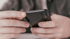 person holding smartphone in both hands
