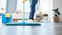 person using mop in living room