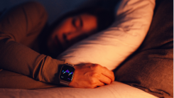 person sleeping while wearing a smartwatch