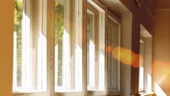 Bright rays of sun streaming through curtainless windows