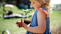 young girl holding plant