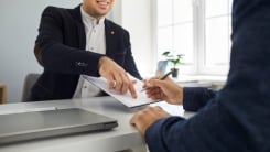 two businesspeople with a contract