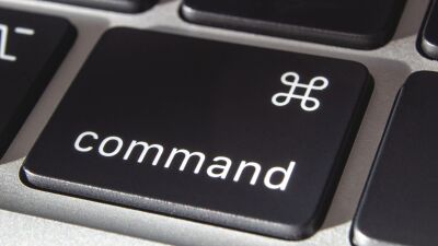 A closeup of a MacBook's "command" key