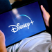 A boy watching Disney+ on a tablet