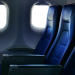 A row of economy/coach seats on an airplane