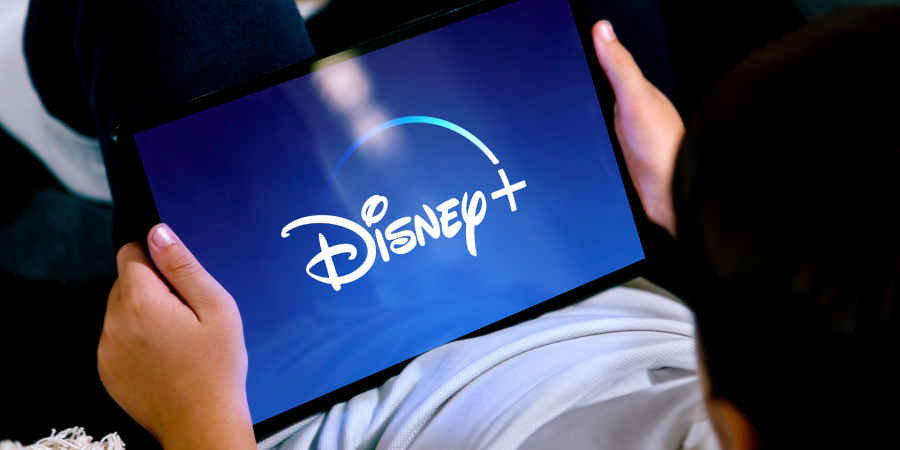 A boy watching Disney+ on a tablet